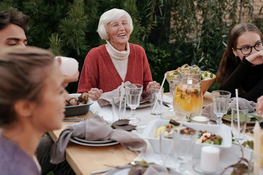 Woman enjoying dinner with her family at their cottage