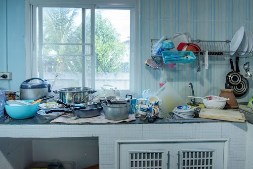 Messy kitchen with dishes all over the place
