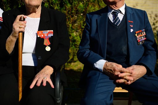 two elderly veterans with medals